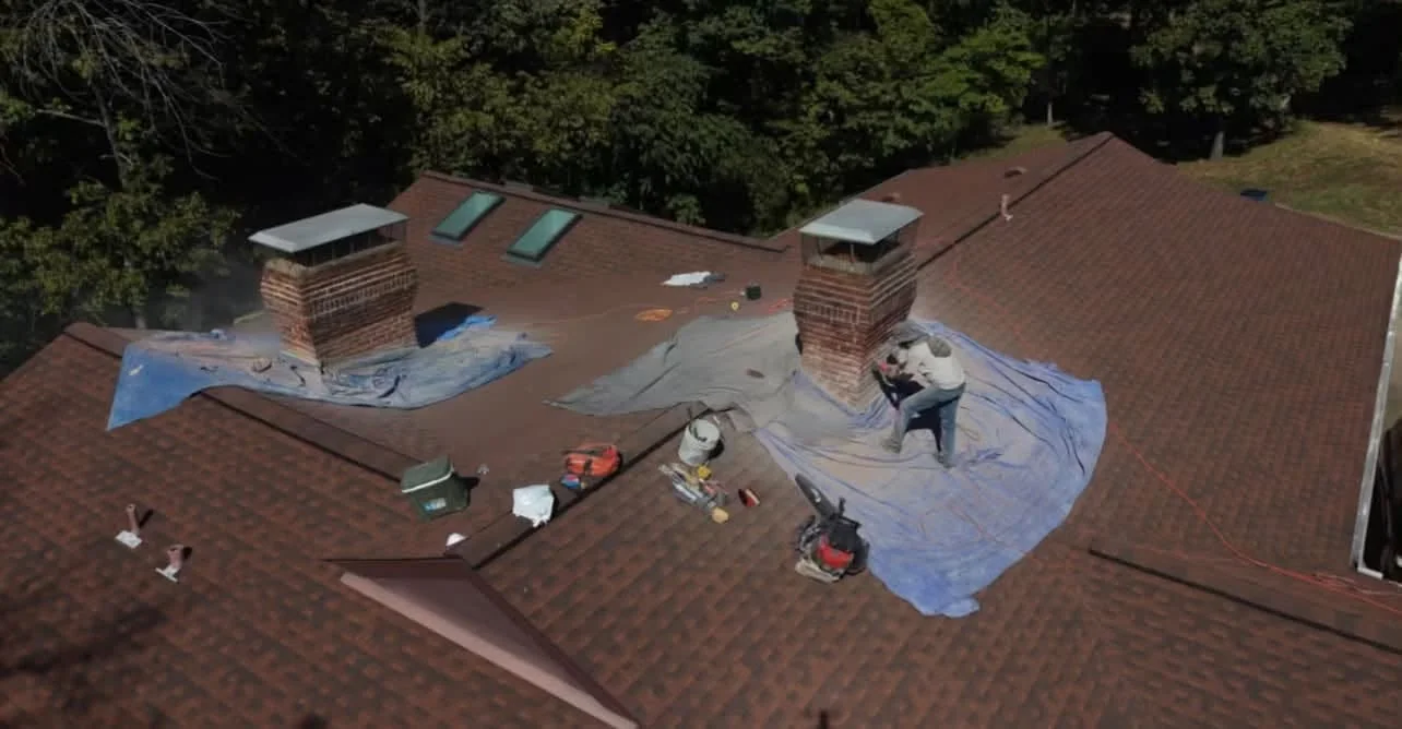 Aerial view of chimneys and protected roof at the same site