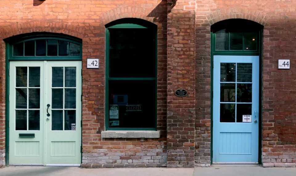 Brick wall with arched brick lintels above windows and doors