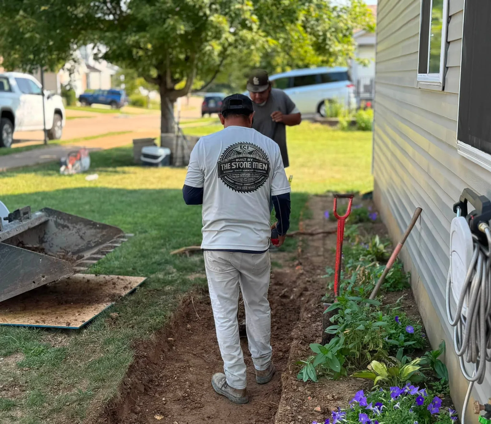 ECI crew members working beside a home during walkway preparation