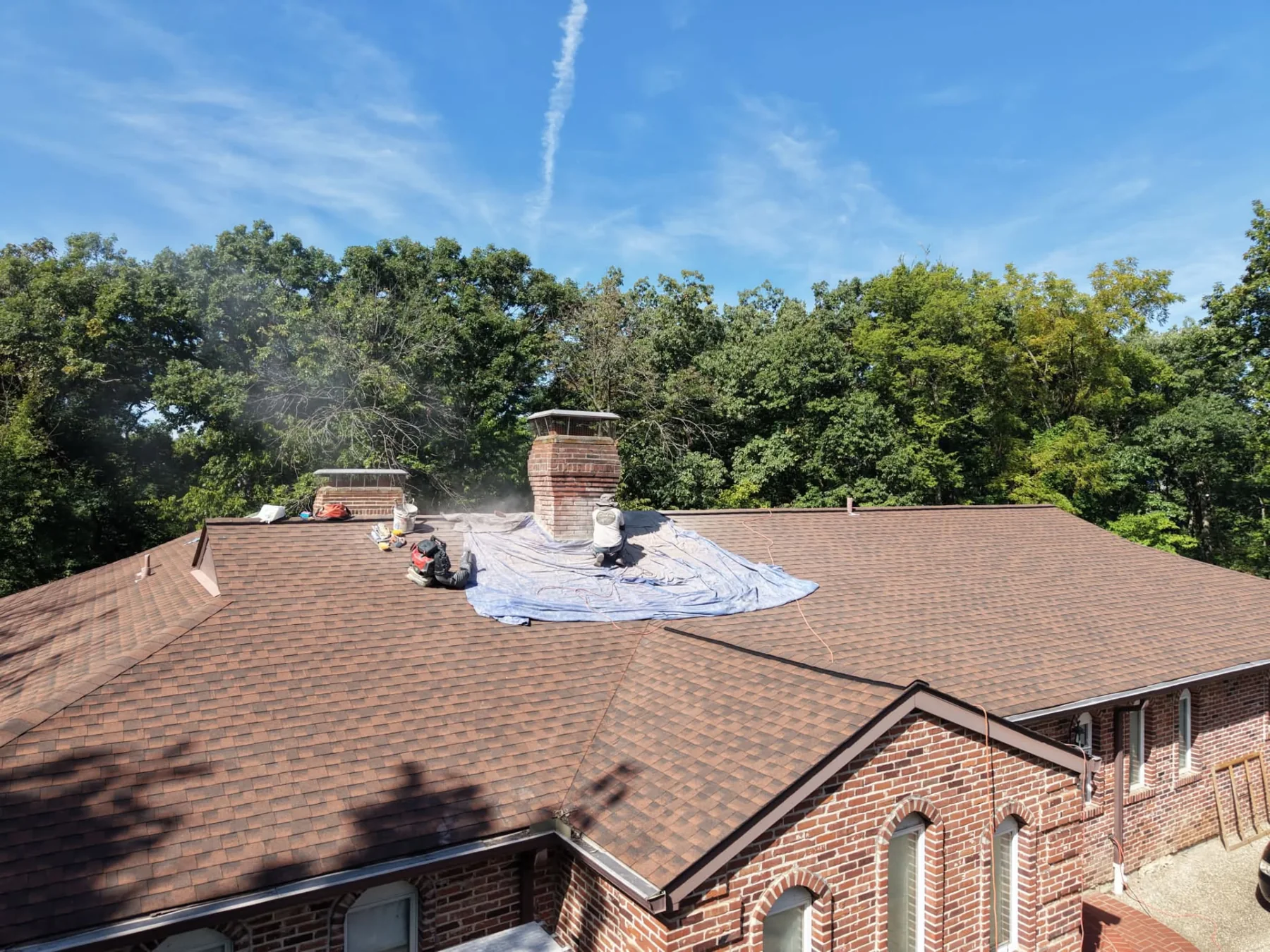 Brick chimney on a residential roof during ECI masonry work