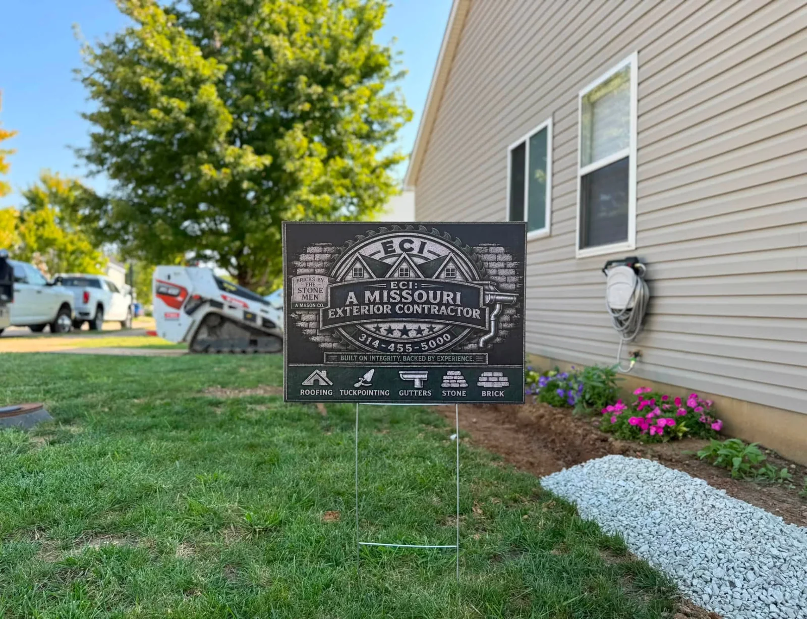 ECI project sign beside a house with landscaping and crushed stone at the worksite