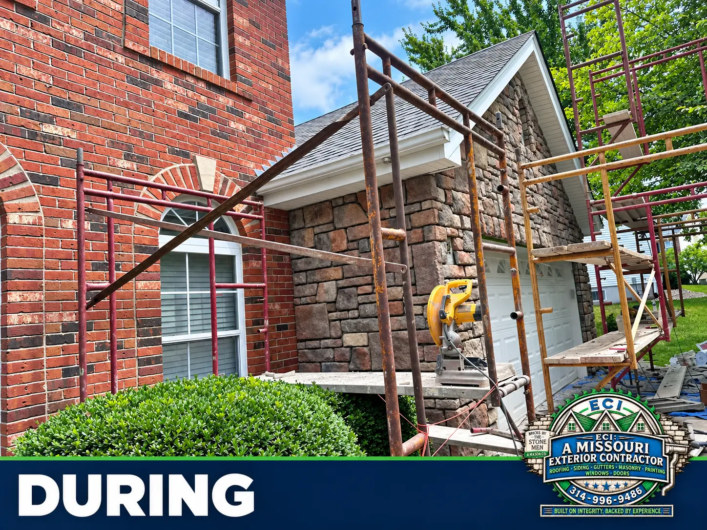Close side view of stonework and scaffolding beside the brick house