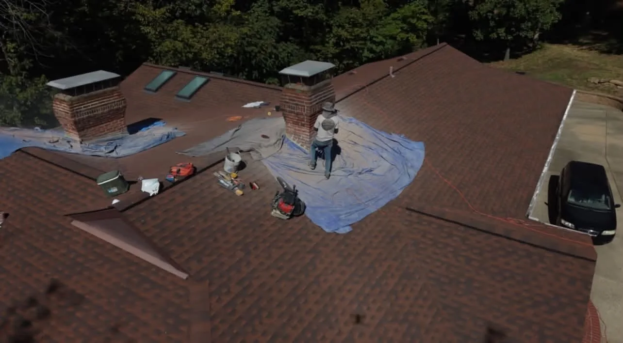 Wide aerial view of two chimneys on a brick residence during masonry work