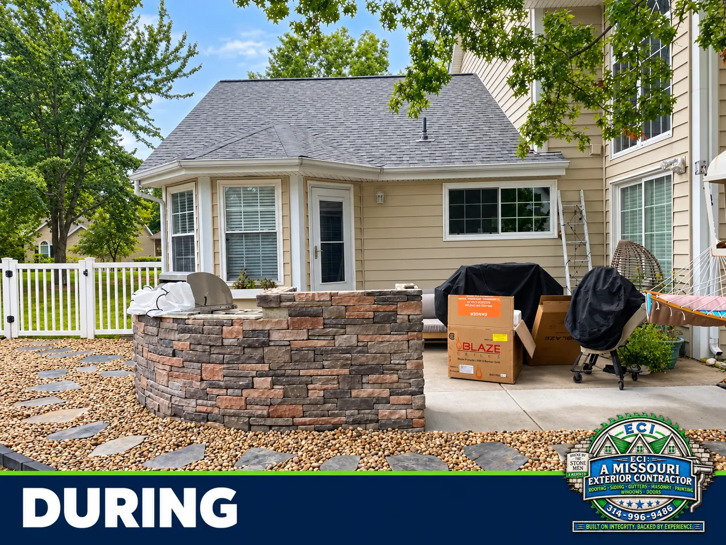 Stone outdoor kitchen under construction with the surrounding paths being prepared